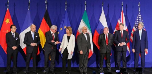 Iranian Foreign Minister and foreign ministers of major world powers stand for a photo after reaching a historic nuclear deal in 2015 that dropped sanctions in exchange for IAEA monitoring