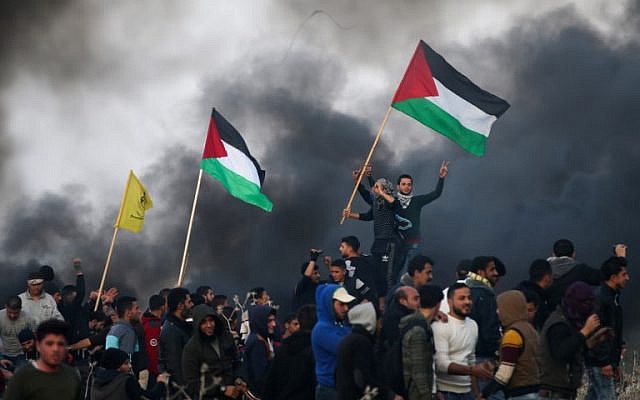 Protesters in Gaza waving Palestinian flags