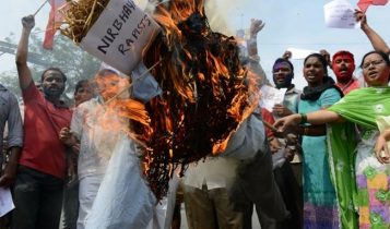 Protesters in India burn an effigy