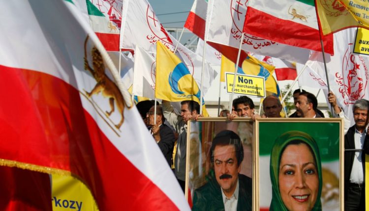 Protesters hold up pictures displaying Massoud and Maryam Rajavi, leaders of exiled Iranian political-militant organization Mojahedin-e Khalqm’s (MEK)