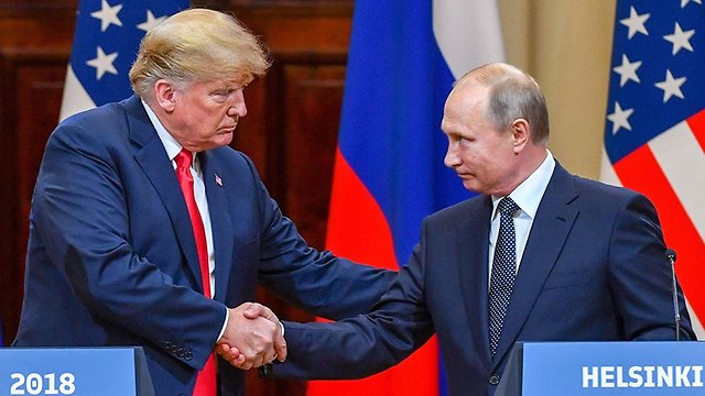 US President Donald Trump and Russian President Vladimir Putin shake hands at their meeting at Helsinki on July 16, 2018