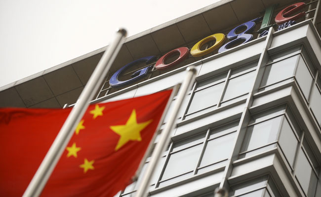 A Chinese flag wavers in front of a Google building.
