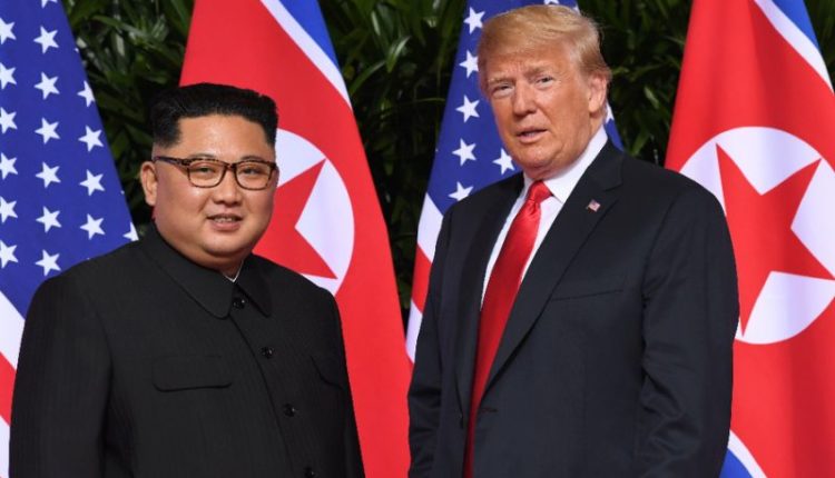 US President Donald Trump and North Korean leader Kim Jong Un Standing in front of the flags of their countries during their meeting in Singapore.
