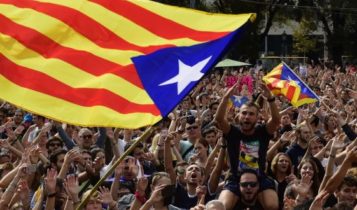 Catalan pro-independence flags wave above a crowd during a protest in Barcelona, Catalonia
