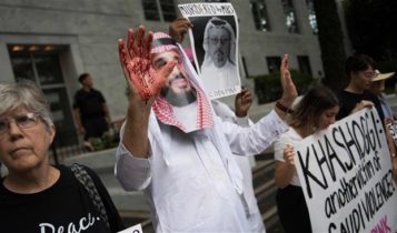 A demonstrator dressed as Saudi Crown Prince Mohammed bin Salman (C) with blood on his hands protests outside the Saudi embassy in Washington, DC after Khashoggi went missing.