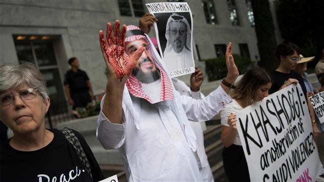 A demonstrator dressed as Saudi Crown Prince Mohammed bin Salman (C) with blood on his hands protests outside the Saudi embassy in Washington, DC after Khashoggi went missing.