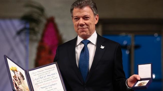 Nobel Peace Prize laureate Colombian President Juan Manuel Santos poses with the medal and diploma during the award ceremony of the Nobel Peace Prize in Oslo, Norway