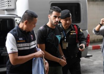 Hakeem al-Araibi being lead into a court in Thailand.