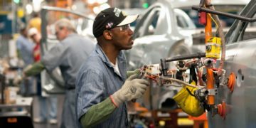 A man at work in U.S. auto-manufacturing plant.