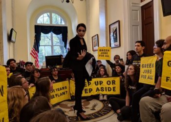 Rep. Alexandria Ocasio-Cortez joins protestors from the Sunrise Movement in the office of Democratic leader Nancy Pelosi on Nov. 13, 2018.