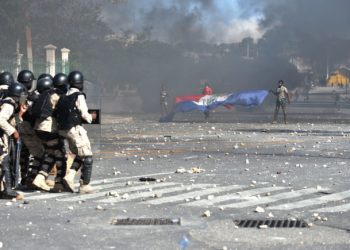 Police try to break up a protest in front of the National Palace in Haiti capital Port-au-Prince