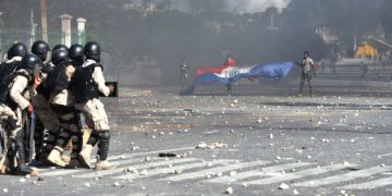 Police try to break up a protest in front of the National Palace in Haiti capital Port-au-Prince