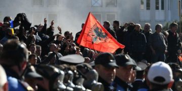 Opposition supporters protesting outside Albania's parliament in February