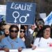 A woman holds a banner reading "Equality" during an International Women’s Day demonstration in the southern French city of Marseille