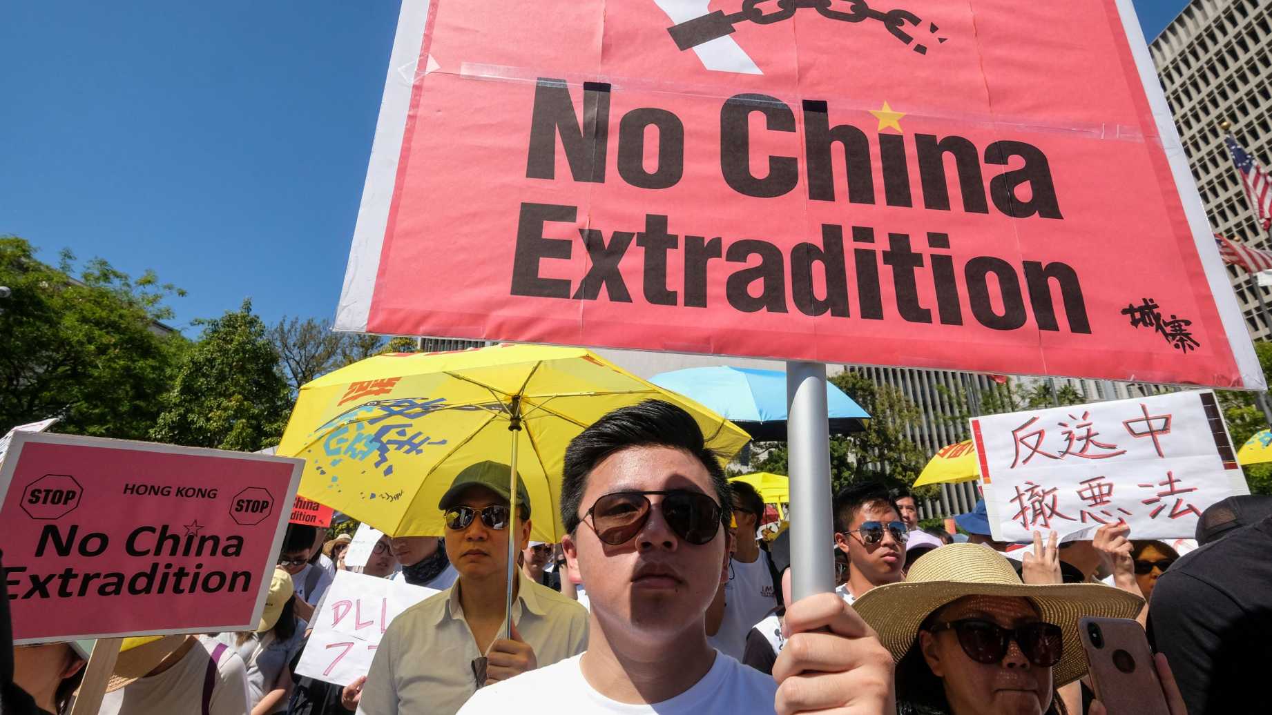 Man protesting in Hong Kong holding up a sign saying 'No China Extradition'