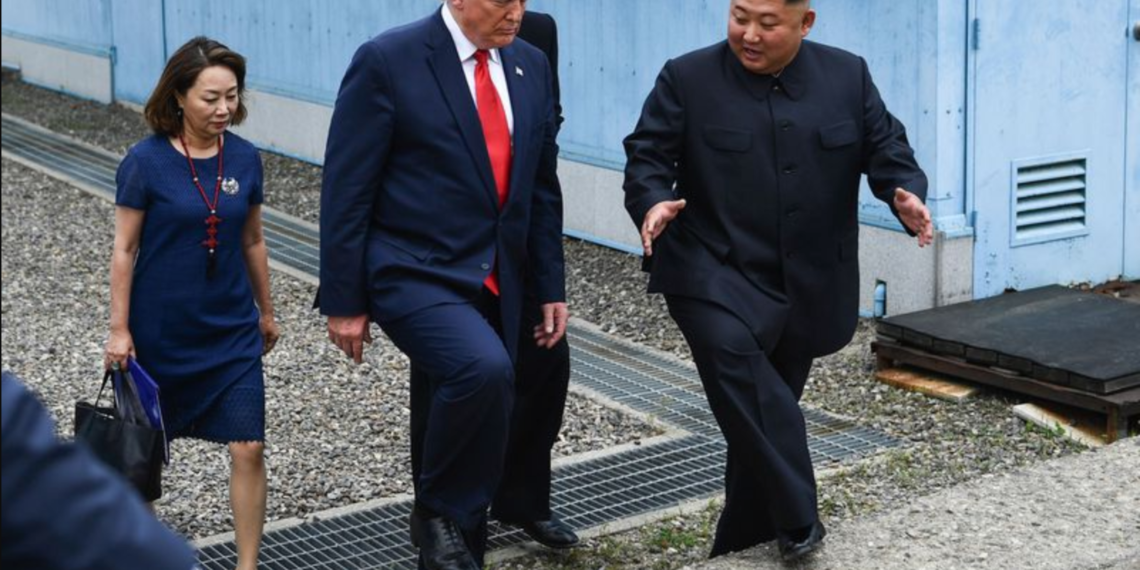 President Donald Trump and North Korean leader Kim Jong Un walk together south of the Military Demarcation Line