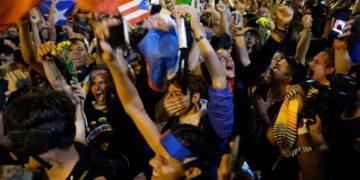 Demostrators erupt in celebration after Puerto Rican Governor Ricardo Rossello.