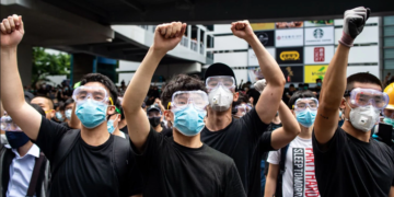 Protesters in masks and goggles chant slogans outside the Legislative Council in Hong Kong on June 12