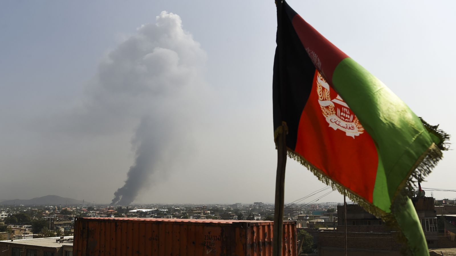 Smoke rises from the site of an attack on Tuesday after a massive explosion the night before near the Green Village in Kabul, Afghanistan