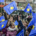 Children wave flags of Kosovo during the 2018 anniversary of the end of its war and the withdrawal of Serbian forces