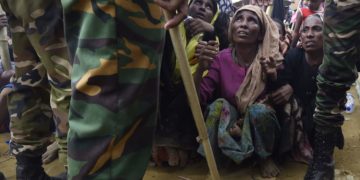 Rohingya refugees wait for food distribution organized by the Bangladesh army at the refugee camp of Balukhali near Gumdhum