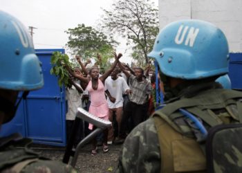 An angry crowd of Haitians confront a group of Brazilian UN peacekeepers