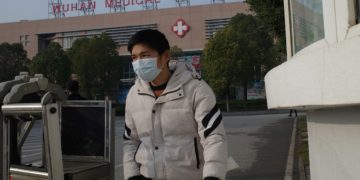 A man leaves the Wuhan Medical Treatment Center, where a man who died from a respiratory illness was being treated, in the city of Wuhan, Hubei province, China, Jan. 12, 2020.