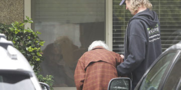Dorothy Campbell, 88, visits her 89-year-old husband Gene through a window at Life Care Center in Kirkland. Gene is under quarantine at the Washington state facility.