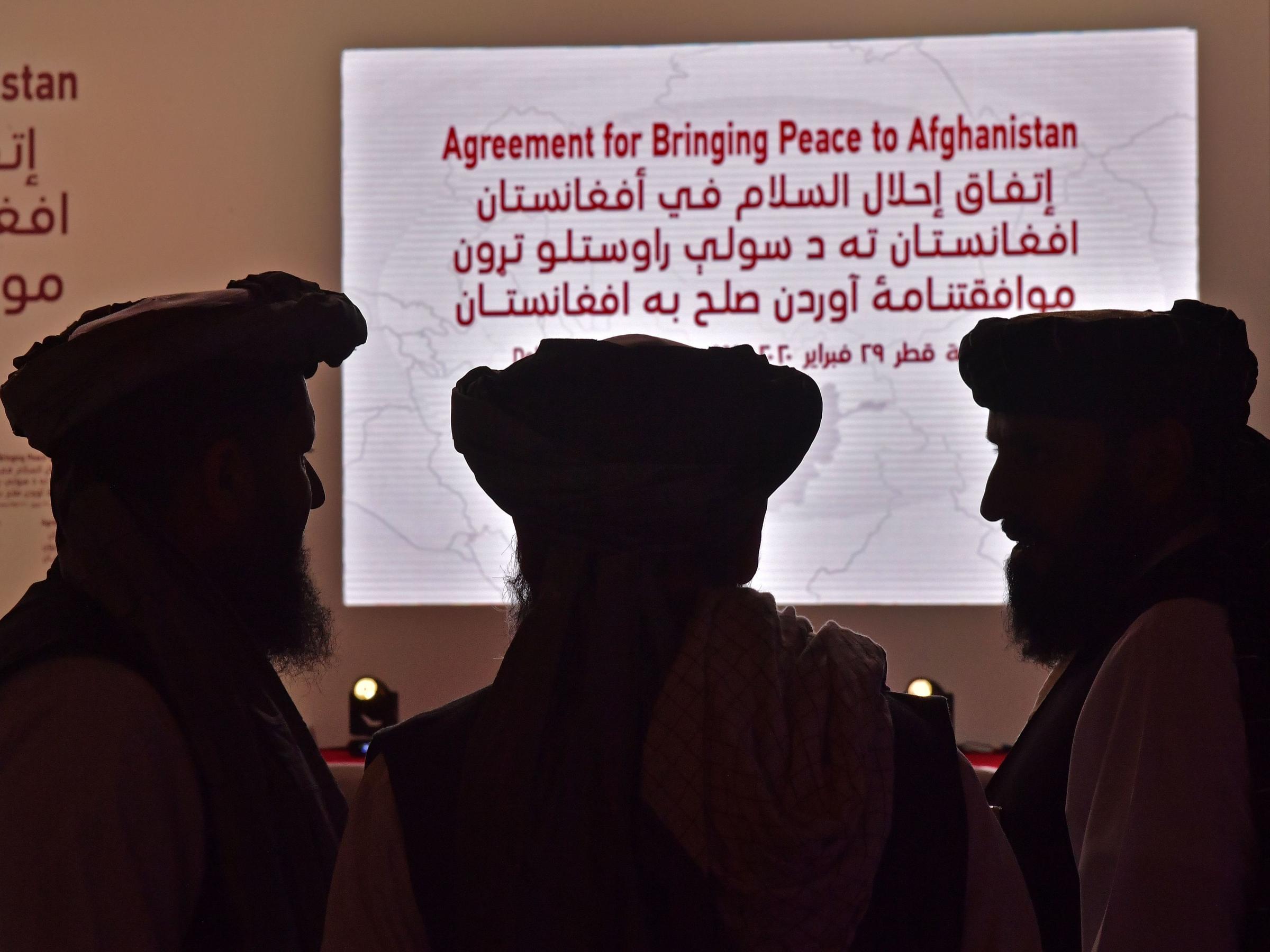 Members of the Taliban delegation gather ahead of the signing ceremony with the United States in the Qatari capital of Doha