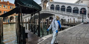 A health official sprays disinfectant in Venice, Italy amid the COVID-19 pandemic