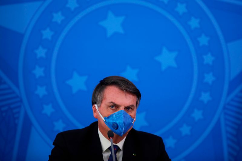 Brazil's President Jair Bolsonaro wears a face mask during a press conference on the coronavirus pandemic COVID-19 at the Planalto Palace in Brasilia, Brazil on March 20, 2020.