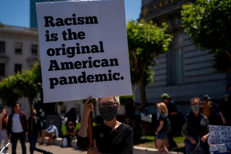 A woman holds a sign during a rally to mark Juneteenth on June 19, 2020, in San Francisco