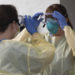 Health care workers from Virginia Hospital Center put on their personal protective equipment before people arrive at a drive-through coronavirus testing site in Arlington, Virginia on March 20, 2020. Photo: Andrew Caballero-Reynolds/AFP.