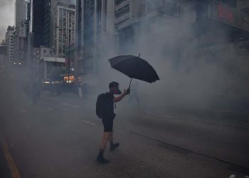 A protester reacts from tear gas fired by police during a 2019 pro-democracy march in Hong Kong