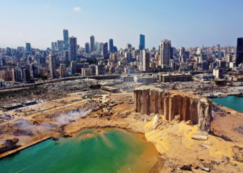 An aerial view of the Beirut port after the explosion. The blast created a 140 meter (460 feet) wide crater that has since filled with sea water. Photo: AFP.