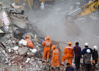 Rescue workers search for survivors in the debris of a collapsed building in Mahad, India on Tuesday. AFP