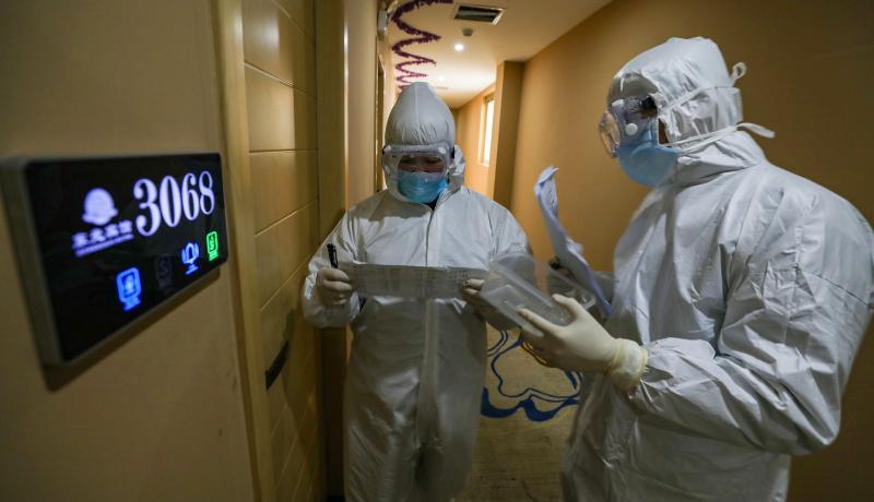 Medical staff in Wuhan, China check in on COVID-19 patients in a quarantine zone