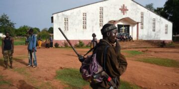 A soldier patrols by a Central African church