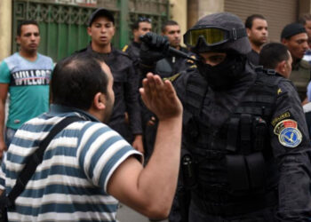 An Egyptian confronting a police officer.