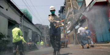 A man disinfecting a street against the spread of coronavirus in Yangon, Myanmar.