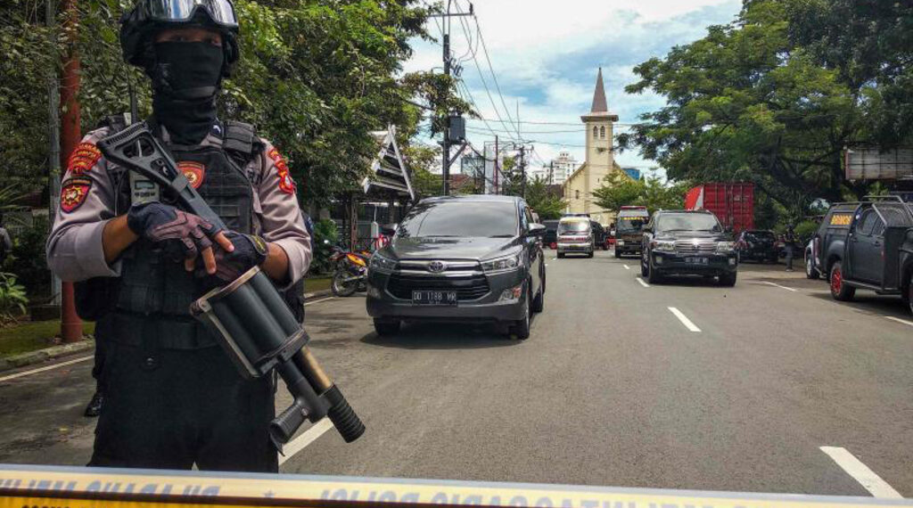 An Indonesian anti-terror policeman stands guard following an explosion outside a church in Makassar, March 28, 2021.