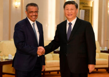 WHO director-general Adhanom Ghebreyesus shakes hands with Chinese President Xi Jinping in Beijing, January 28 2020.