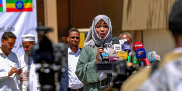 Members representing African communities in Yemen speak outside the offices of the International Organization for Migration in Sanaa, following last weekend’s fire in a holding facility, March 14, 2021.