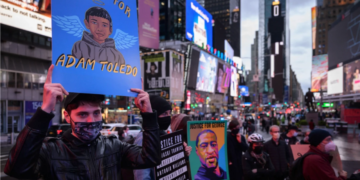 Protestor holding a sign for Adam Toledo