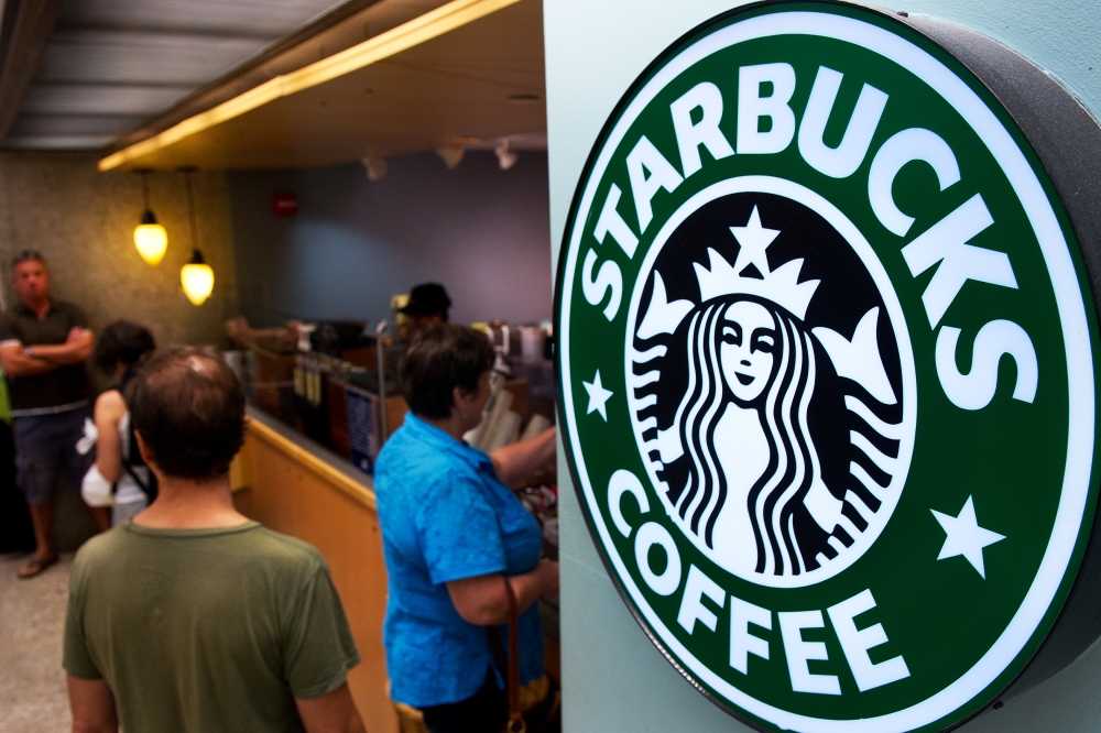 Customers queue for coffee at Starbucks