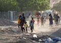 Children and families flee their neighbourhoods amid fighting in Khartoum, Sudan