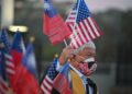 A man holds US, Taiwan flags