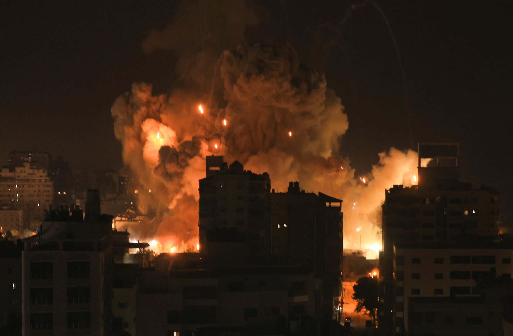 Fire and smoke rise above buildings in Gaza City during an Israeli airstrike