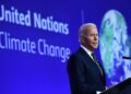 US President Joe Biden delivers a speech on stage during a meeting at the COP26 UN Climate Change Conference