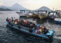 People travel on a wooden boat with motor scooters to Tidore Island ahead of Eid al-Fitr, which marks the end of the Muslim fasting month of Ramadan, at Bastiong port in Ternate, North Maluku